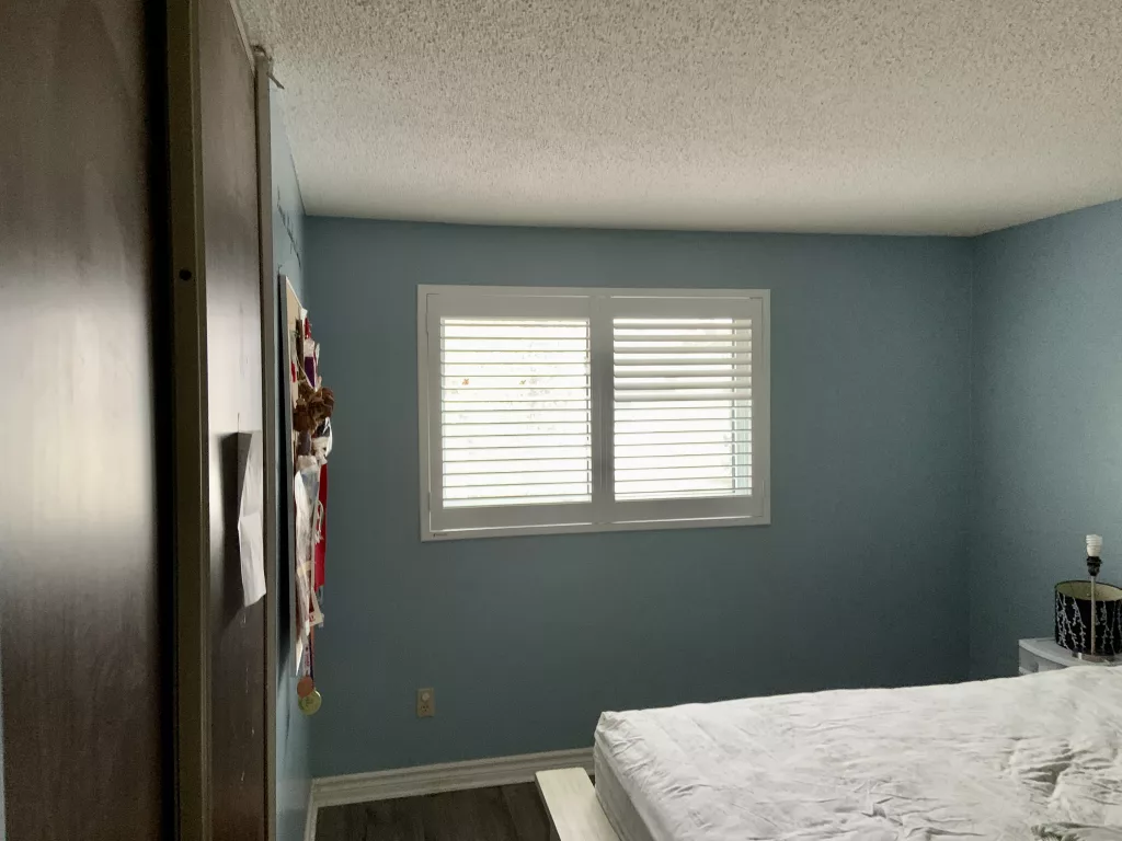 Bedroom with PVC California Shutters from ShutterLux