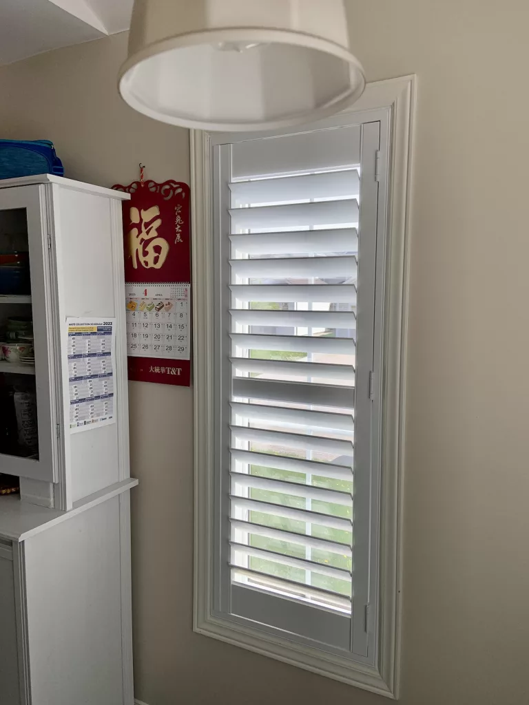 Dining room with California shutters installed by ShutterLux