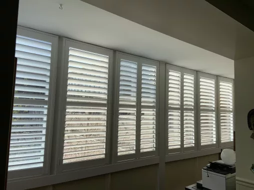 Wide PVC shutters from ShutterLux for very wide window in a condo