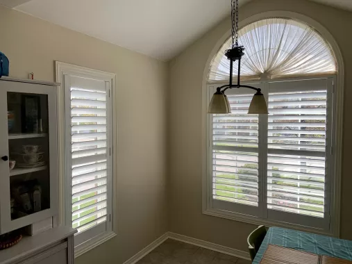 Dining room with California shutters installed by ShutterLux